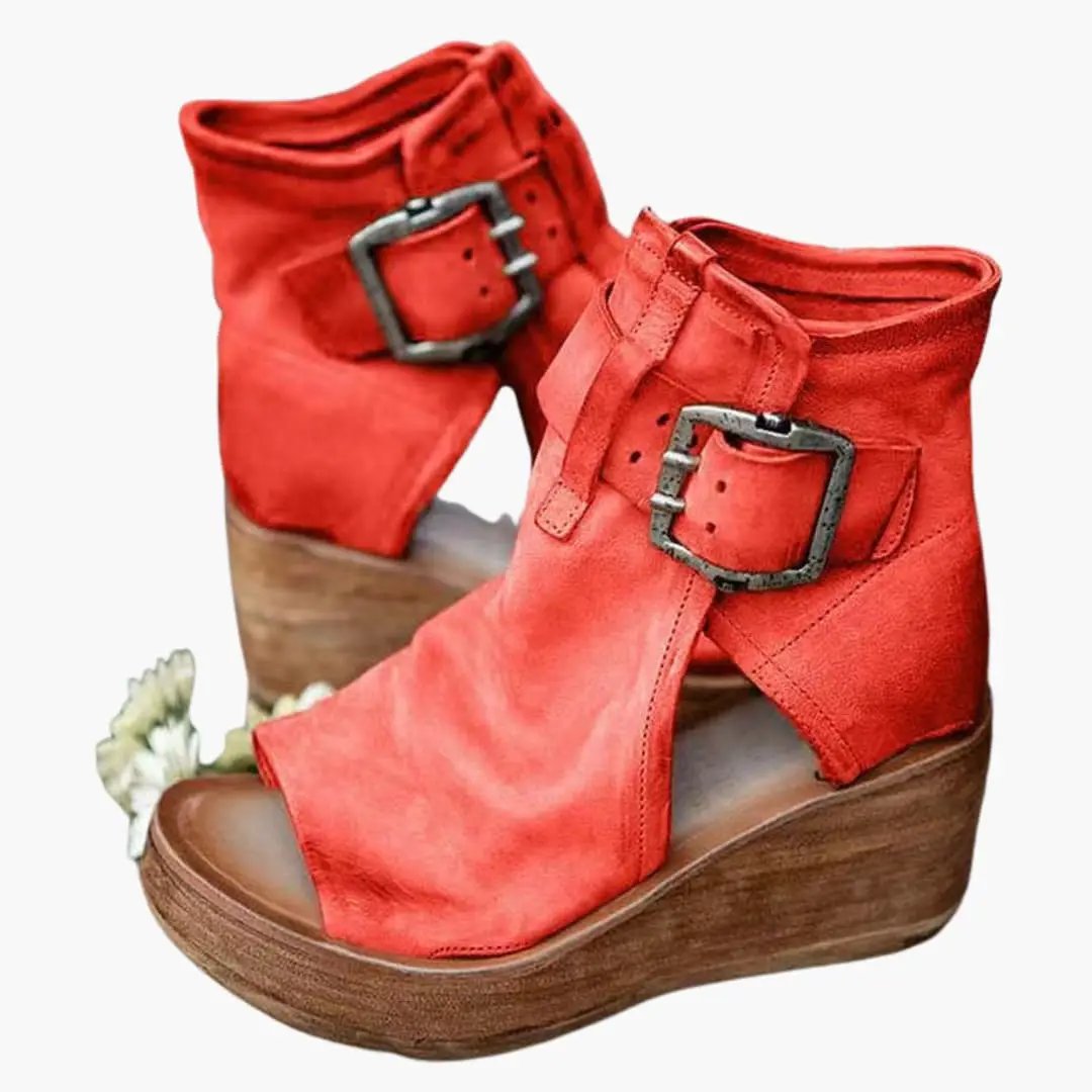 Women's red wedge sandals with buckle straps, contoured sole and wooden wedge heel