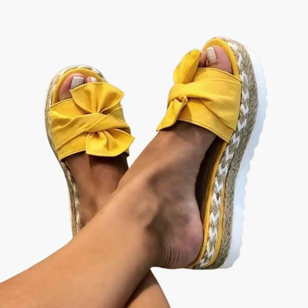 Women's wedge sandals with woven upper and yellow bow detail by Wilfred Smith
