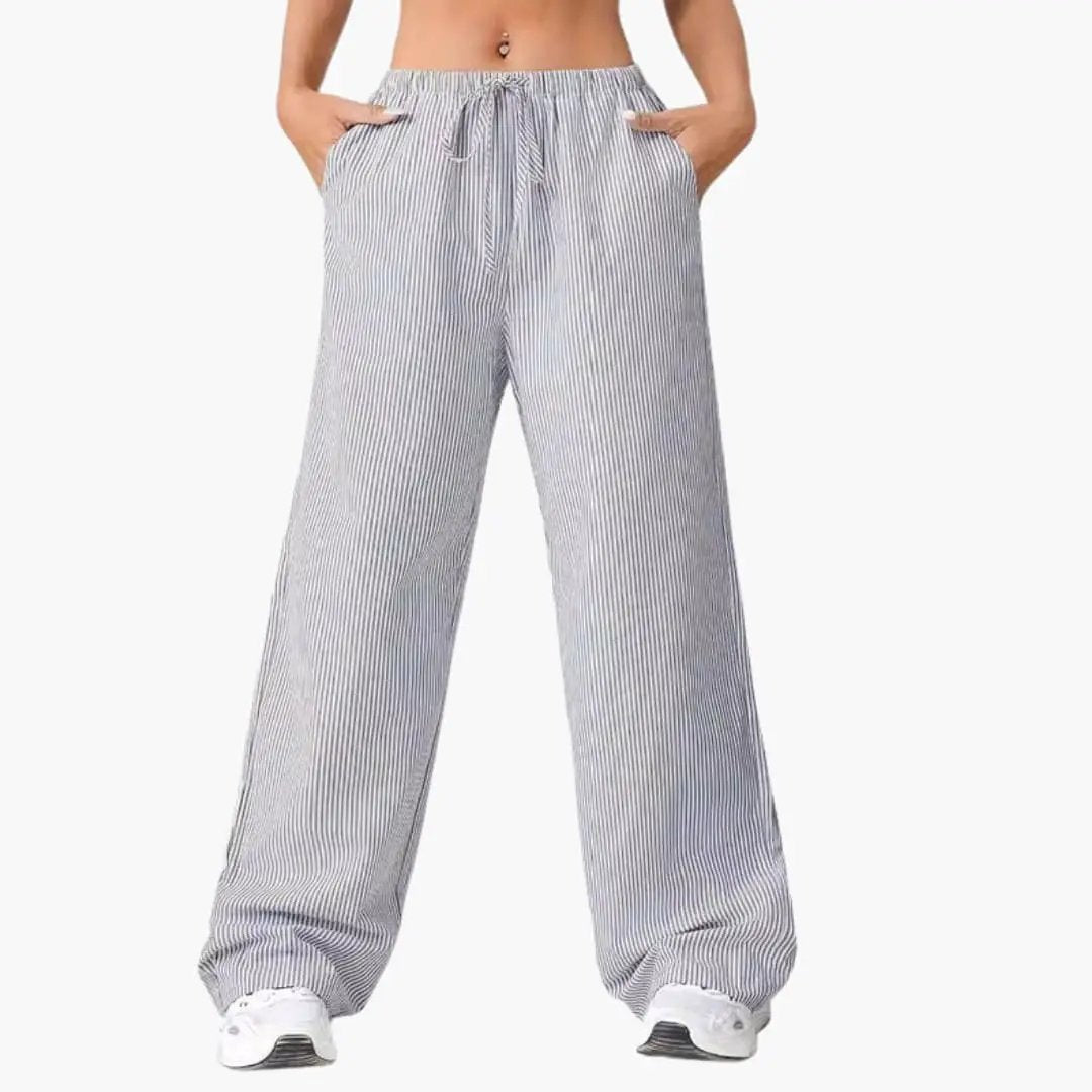 Women’s wide-leg striped pants with a drawstring waist and side pockets in blue and white by Wilfred Smith.