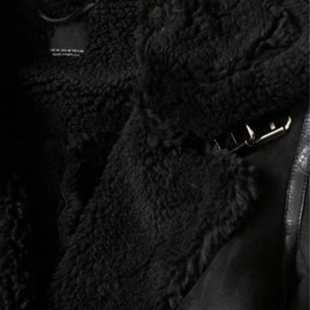 Women’s zip jacket with plush black shearling lining and adjustable belt hem